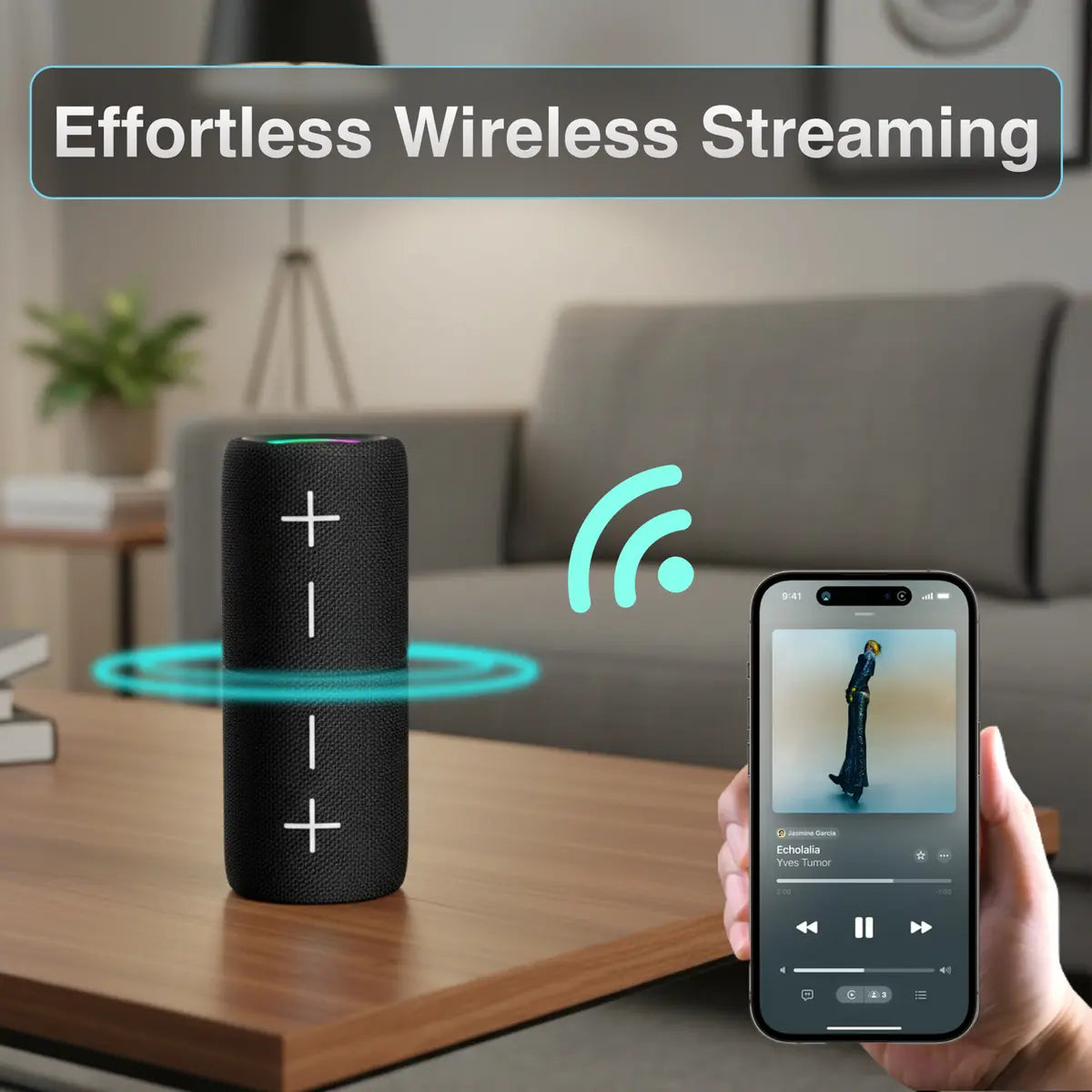 Black wireless speaker on a table with a smartphone displaying music app, indicating wireless streaming.
