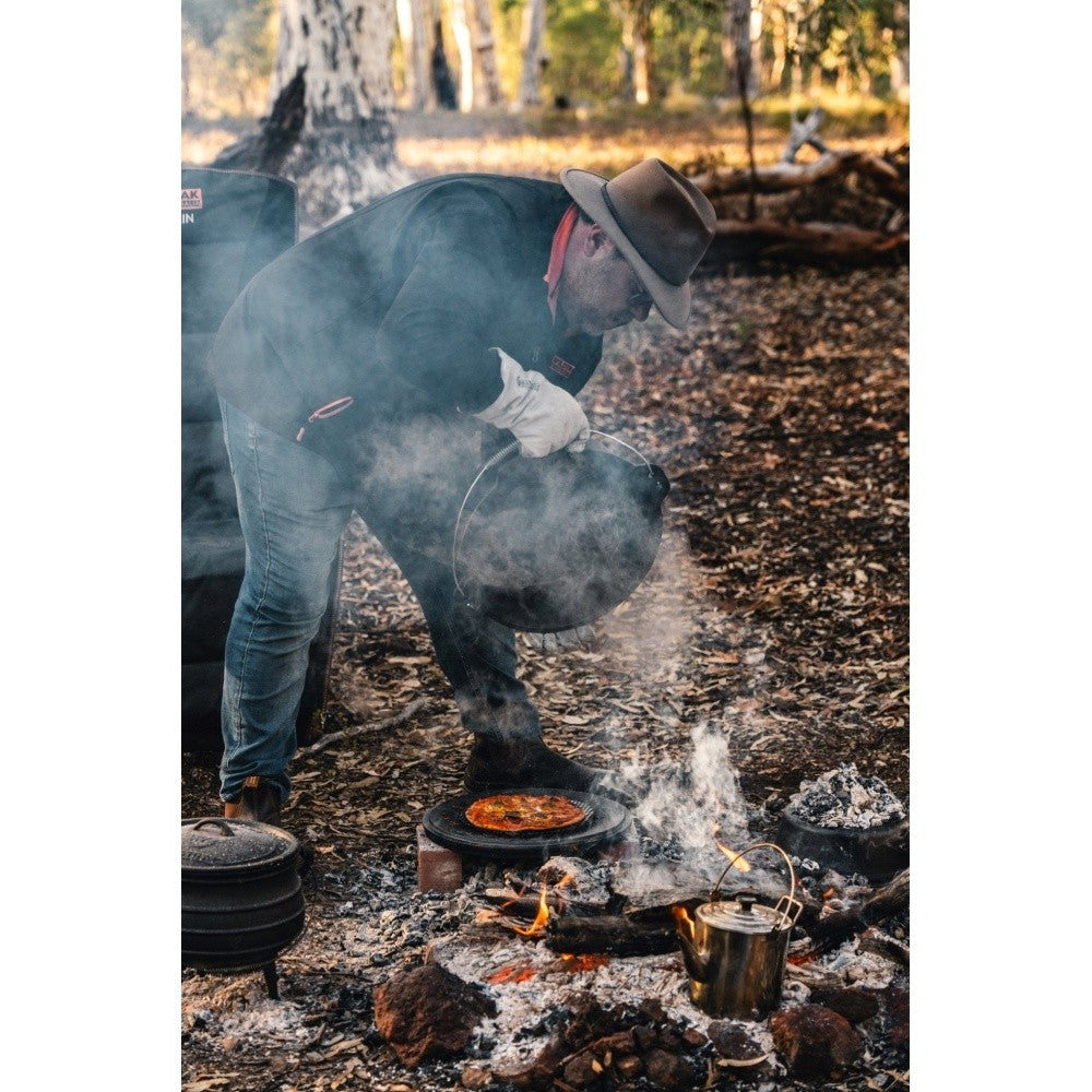 Wildtrak camp oven cooking over campfire coals